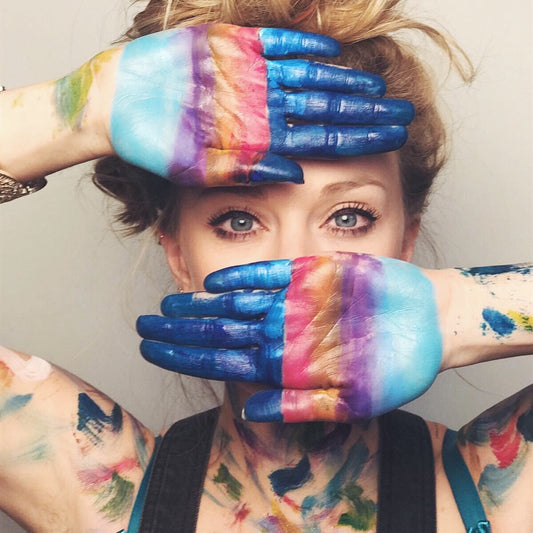 women with hands painted in colours