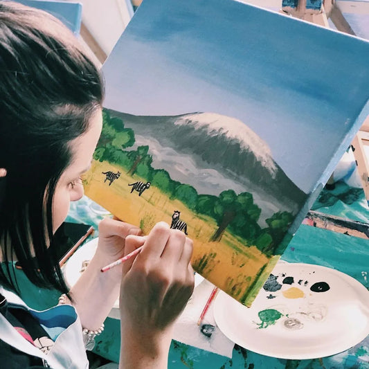 woman painting Mount Kilimanjaro