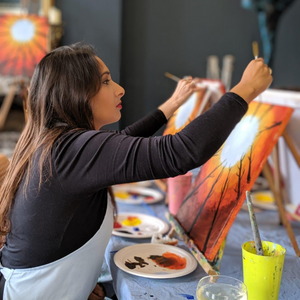 Woman paints acrylic painting of autumn inspired artwork