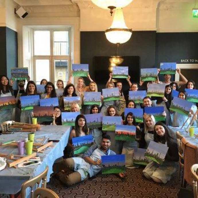 group poses with their paintings of the London skyline