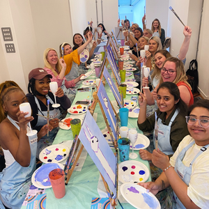 group of coworkers painting at sip and paint work special occasion