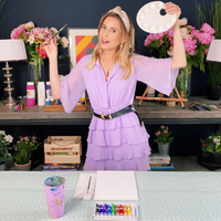 girl posing with painting supplies before following an online painting class